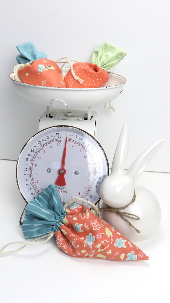 drawstring carrot bags on a kitchen scale with a ceramic bunny