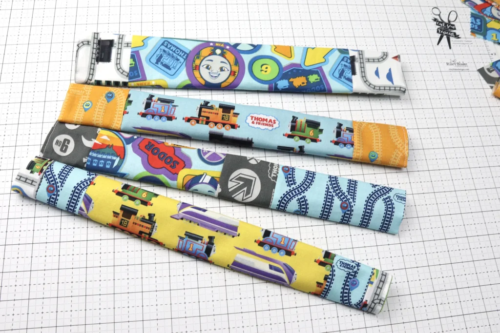 4 shopping cart handle covers made with Thomas & Friends™ Full Steam Ahead fabric from Riley Blake Designs
