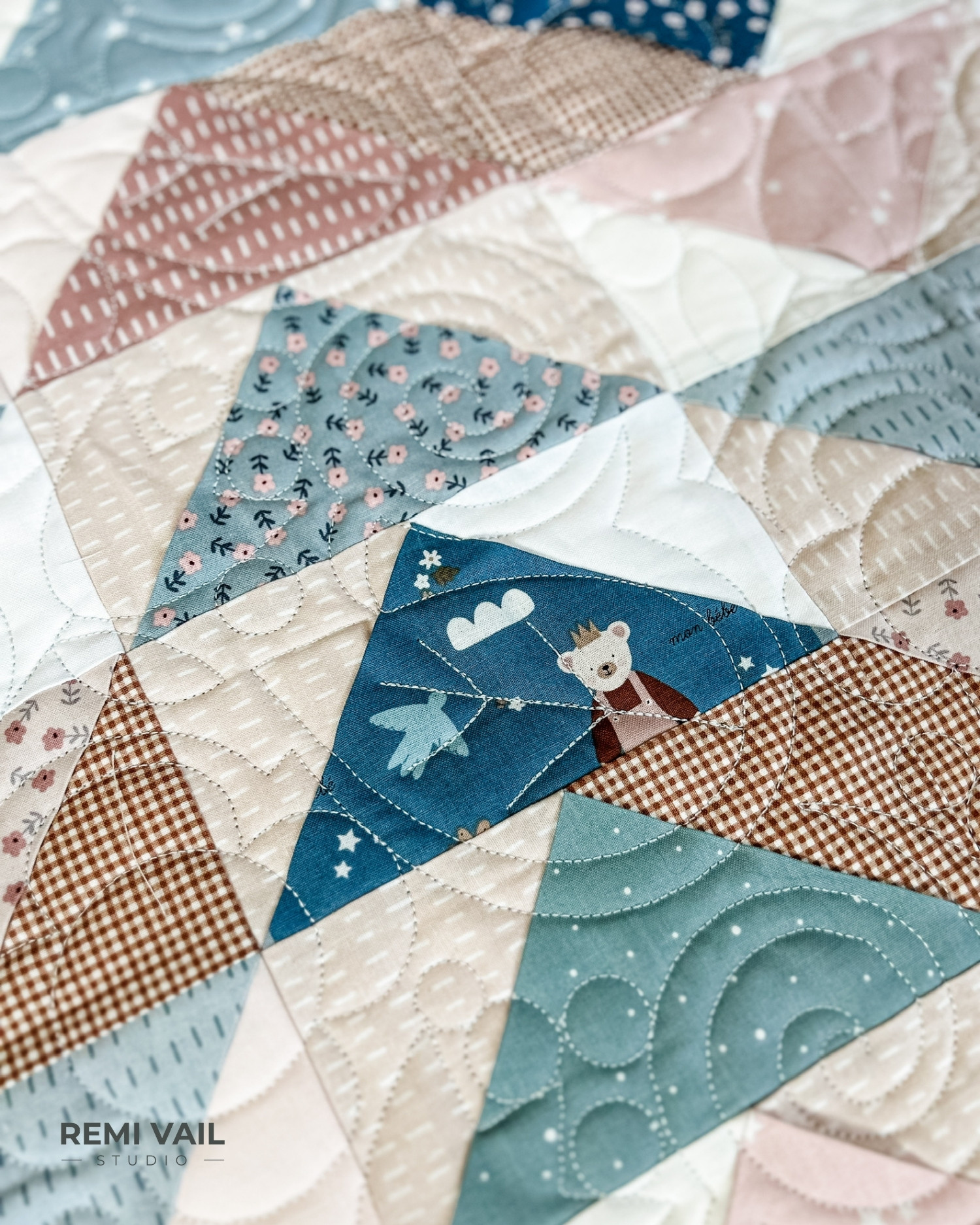 Front Porch Quilt made by Remi Vail Studio using the Cozy Bebe fabric collection by Riley Blake Designs. Quilting is shown up close. Quilt design is Cottage Core by Sew Shabby Quilting.