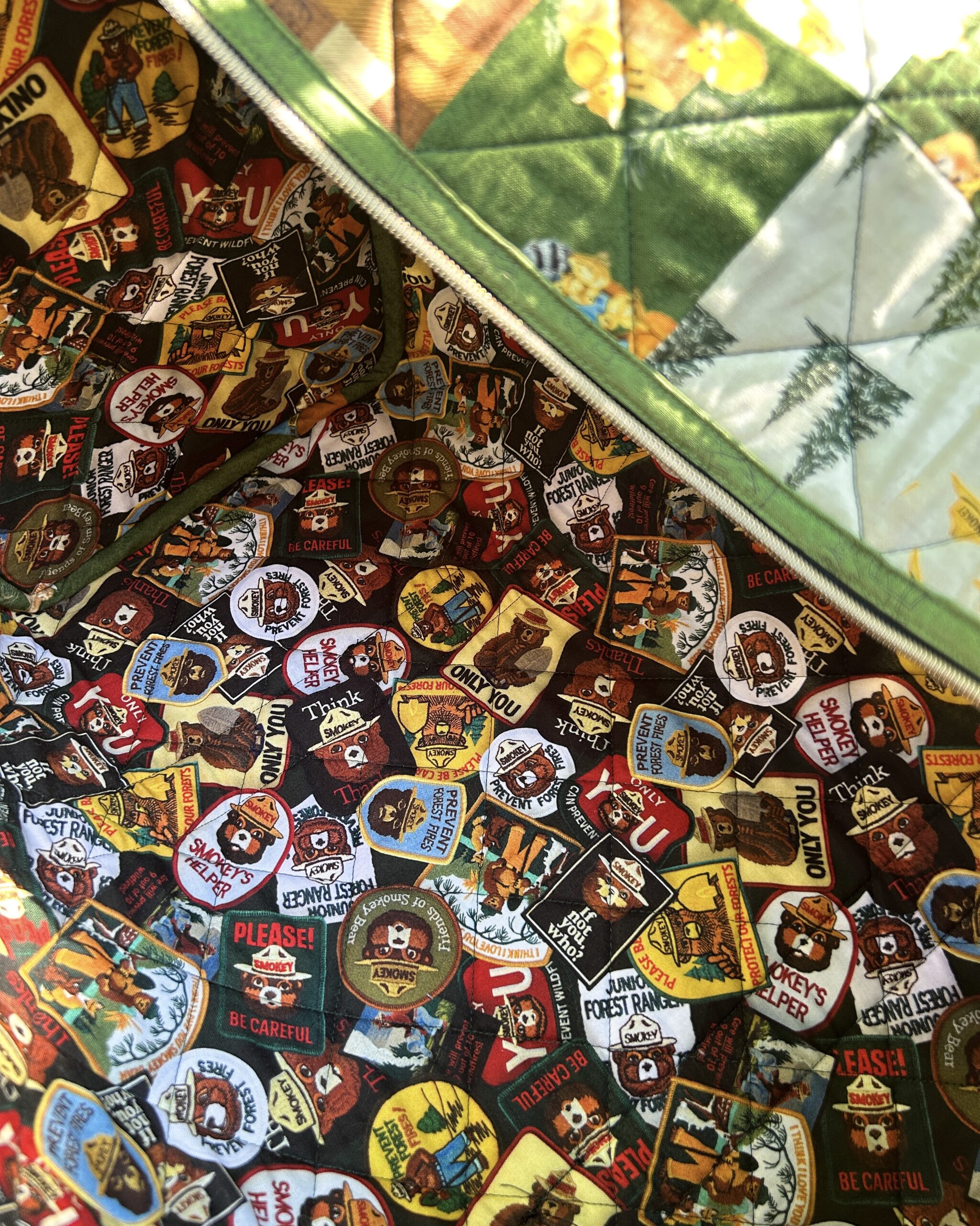 Top view of the duffle bag showing the colourful interior lining with various Smokey Bear patches.