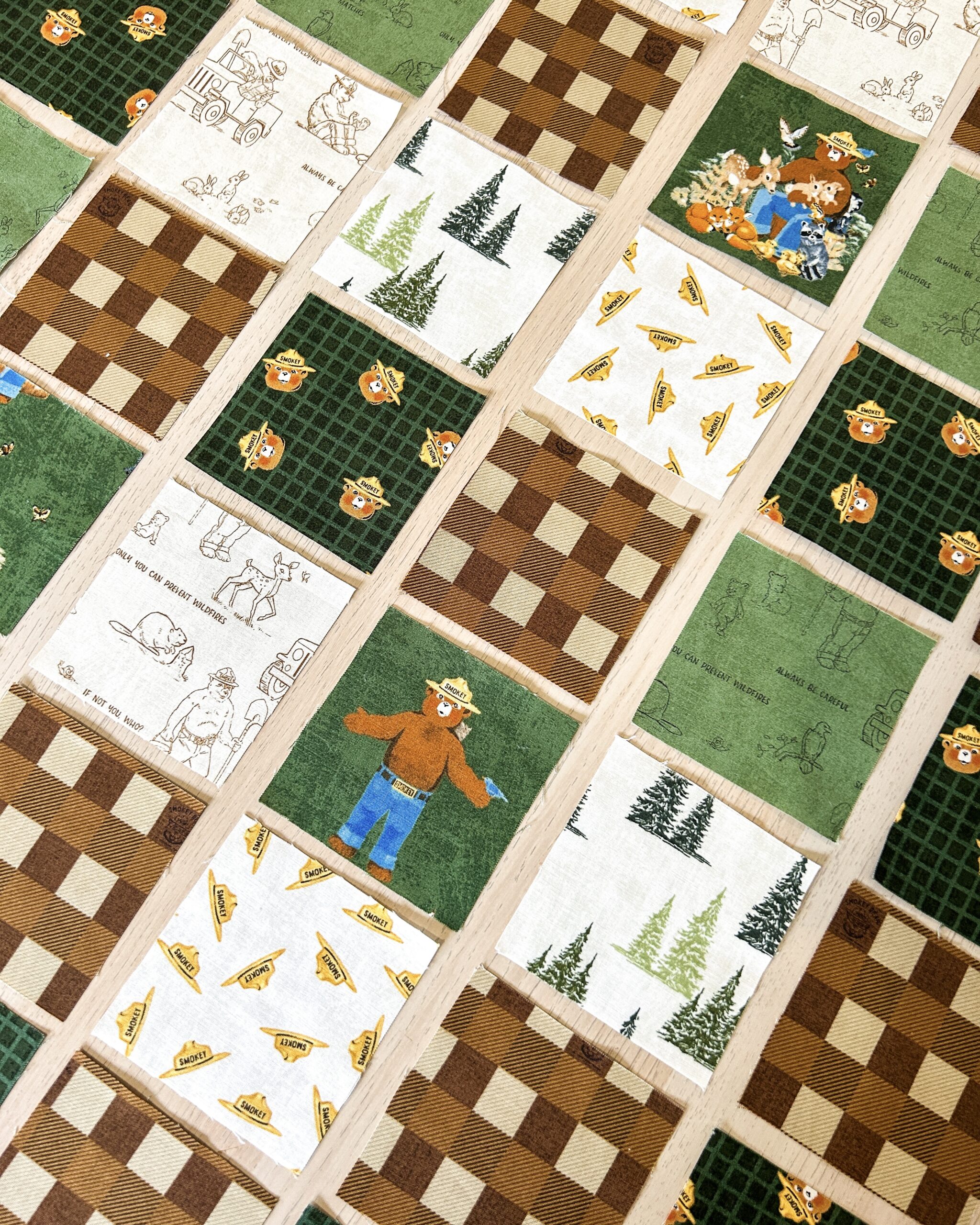 Various cut fabric blocks organized in rows on a table.