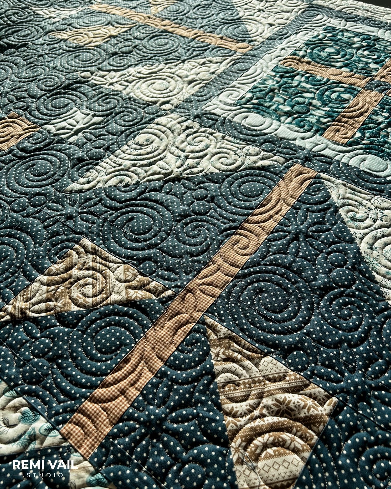 Swirly Snowflakes quilting shown up close. Lumi Quilt by Remi Vail Studio made by Tamara Darragh using the Winter Magic Fabric Collection designed by Dani Mogstad for Riley Blake Designs. 