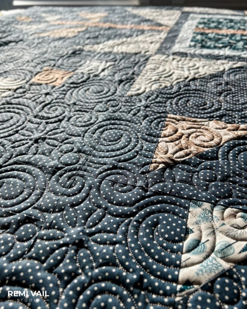 Swirly Snowflakes quilting shown up close. Lumi Quilt by Remi Vail Studio made by Tamara Darragh using the Winter Magic Fabric Collection designed by Dani Mogstad for Riley Blake Designs. 