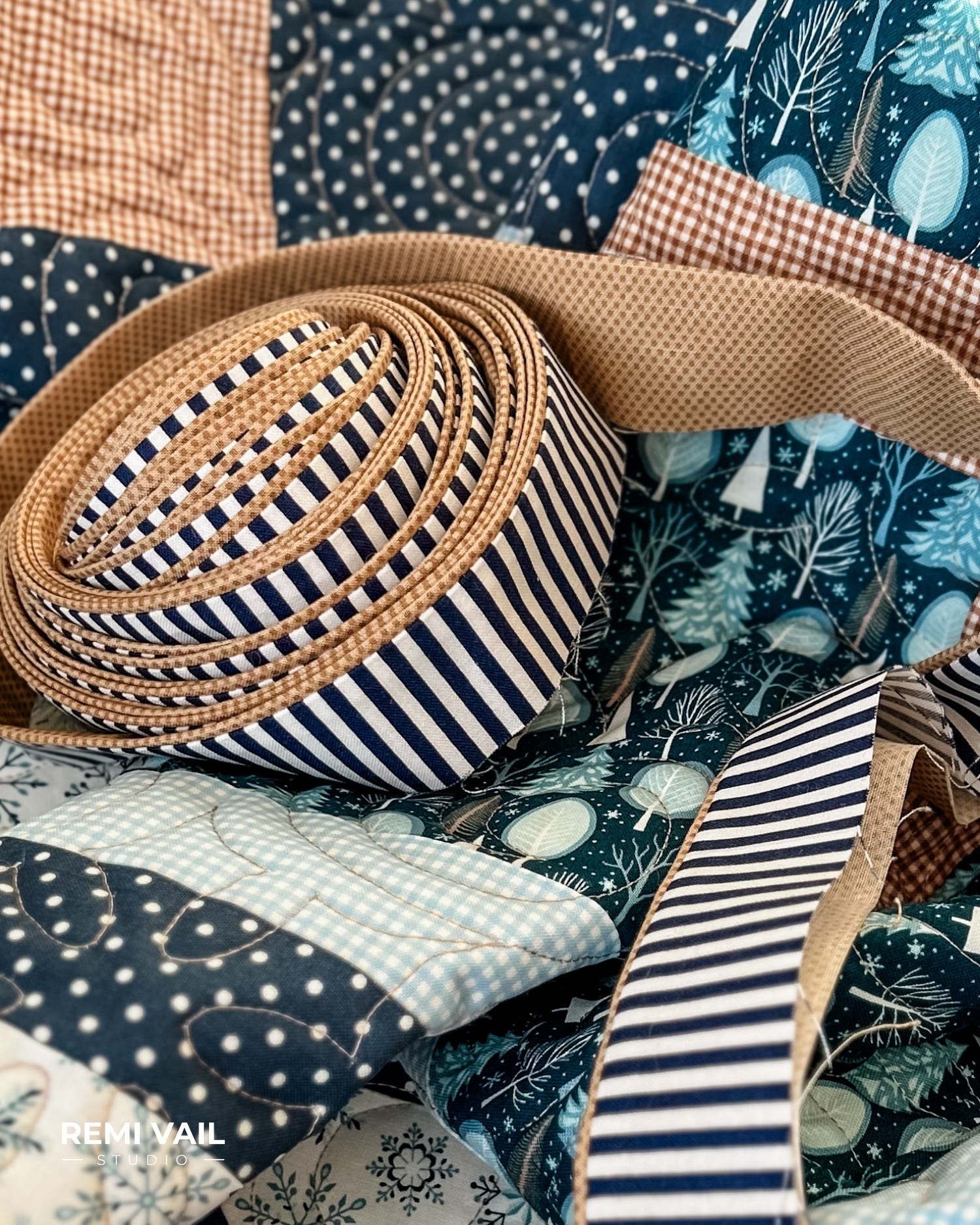 Navy striped flange binding. Lumi Quilt by Remi Vail Studio made by Tamara Darragh using the Winter Magic Fabric Collection designed by Dani Mogstad for Riley Blake Designs.  