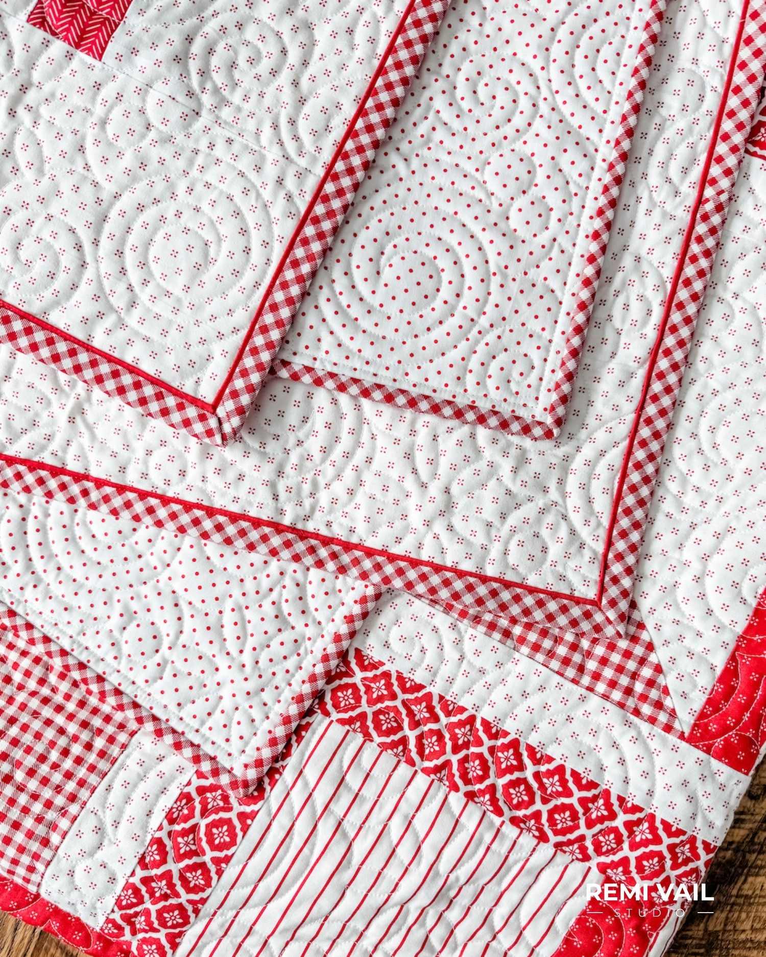 Quilting and flange binding details on the Lumi Quilt pattern by Tamara Darragh of Remi Vail Studio, featuring red and white fabrics from the Radiant Ruby collection by Riley Blake Designs.
