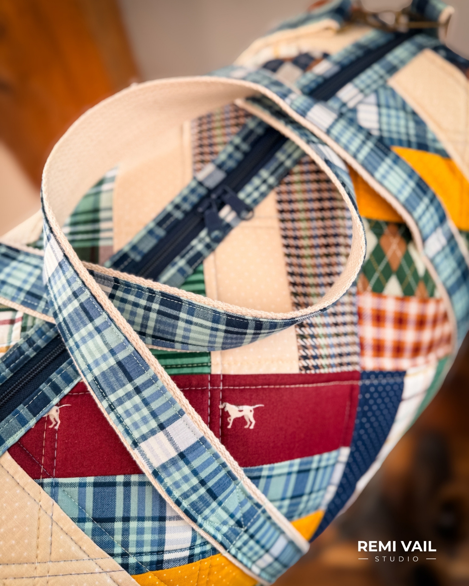 Patchwork Duffle made from Plaid Venture Club Fabric Collection. Made by Tamara Darragh of Remi Vail Studio. Duffle sitting on stool.