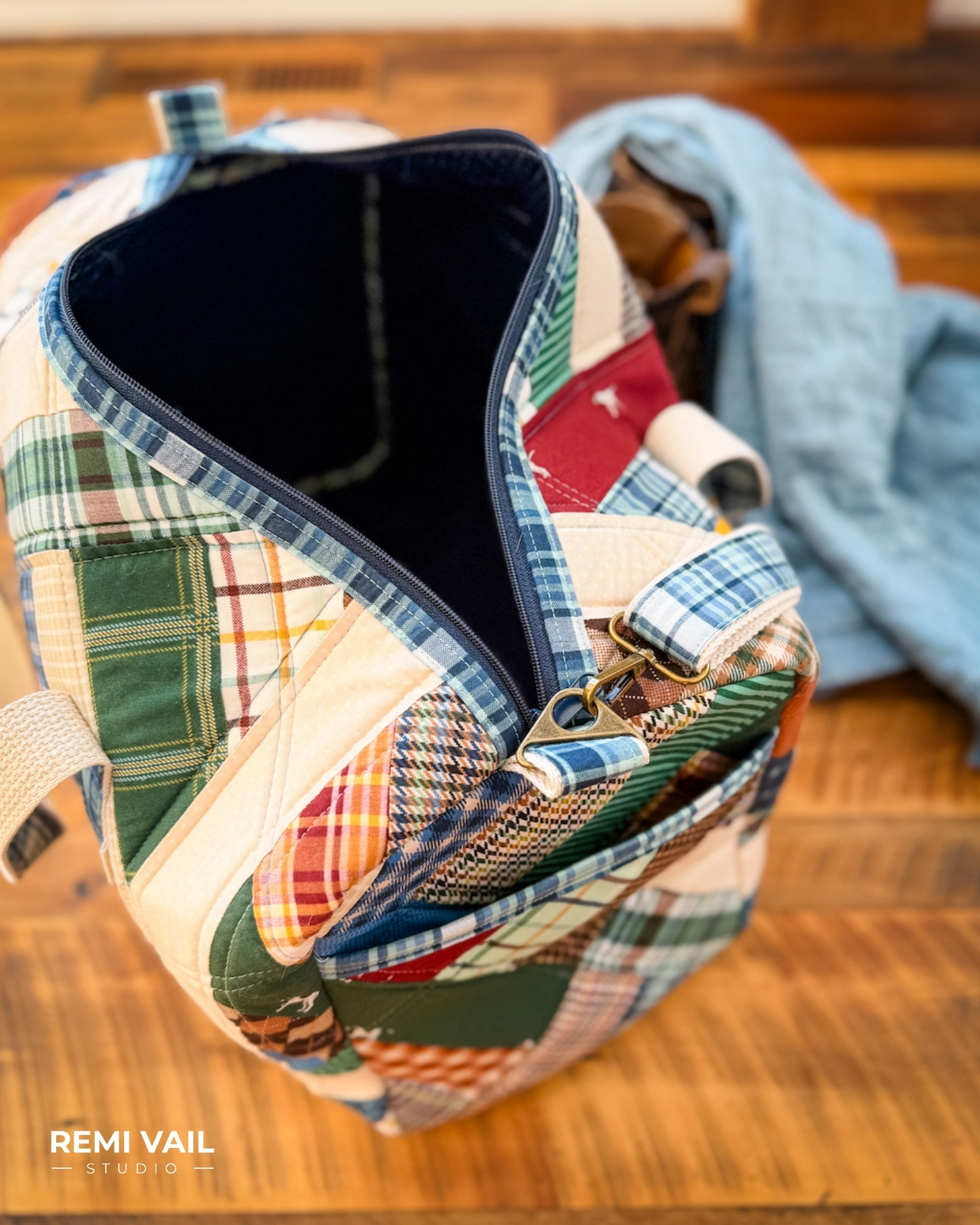 Patchwork Duffle made from Plaid Venture Club Fabric Collection. Made by Tamara Darragh of Remi Vail Studio. Duffle sitting on stool.