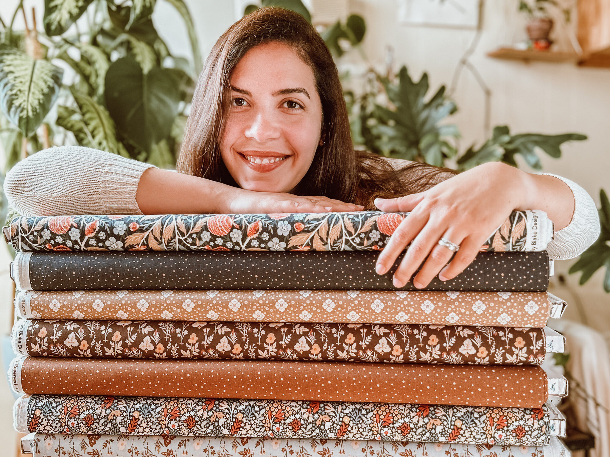 Danelys Sidron, surface pattern designer and illustrator, with Riley Blake Designs fabric collections, including The Old Garden, photographed in her studio.