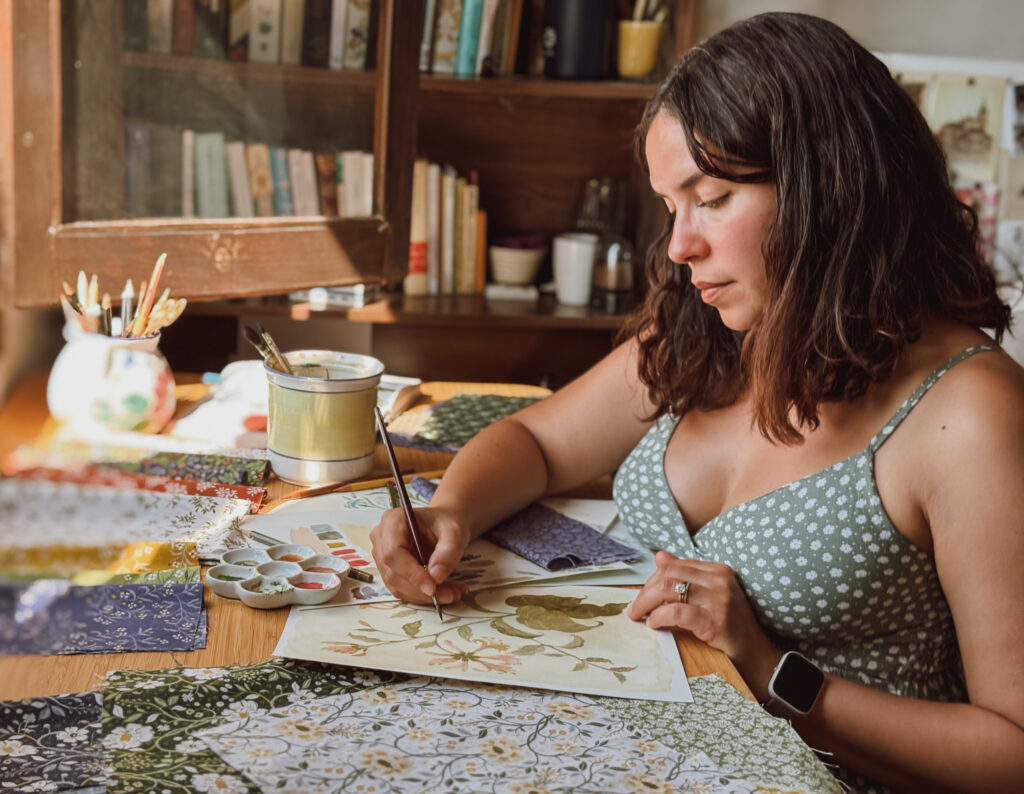 Danelys Sidron painting original watercolor floral artwork for the Before the Bloom quilt fabric collection by Riley Blake Designs, surrounded by coordinating fabric swatches.