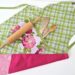 Finished reversible apron with hydrangea pocket and baking tools.