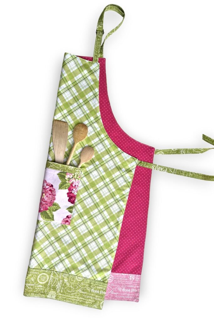 Reversible apron sewn with applegreencottage apron pattern with hydrangea pocket and green plaid fabric.
