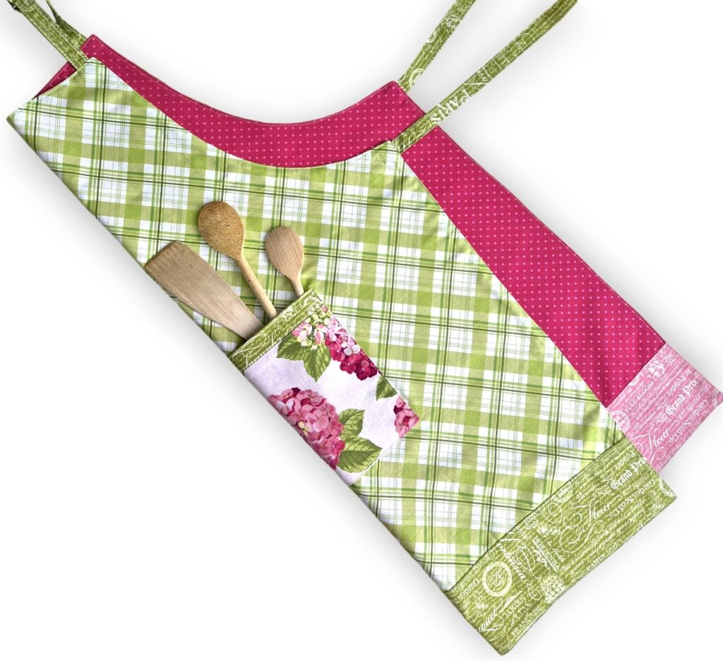 Reversible apron sewn with applegreencottage apron pattern with hydrangea pocket and green plaid fabric.